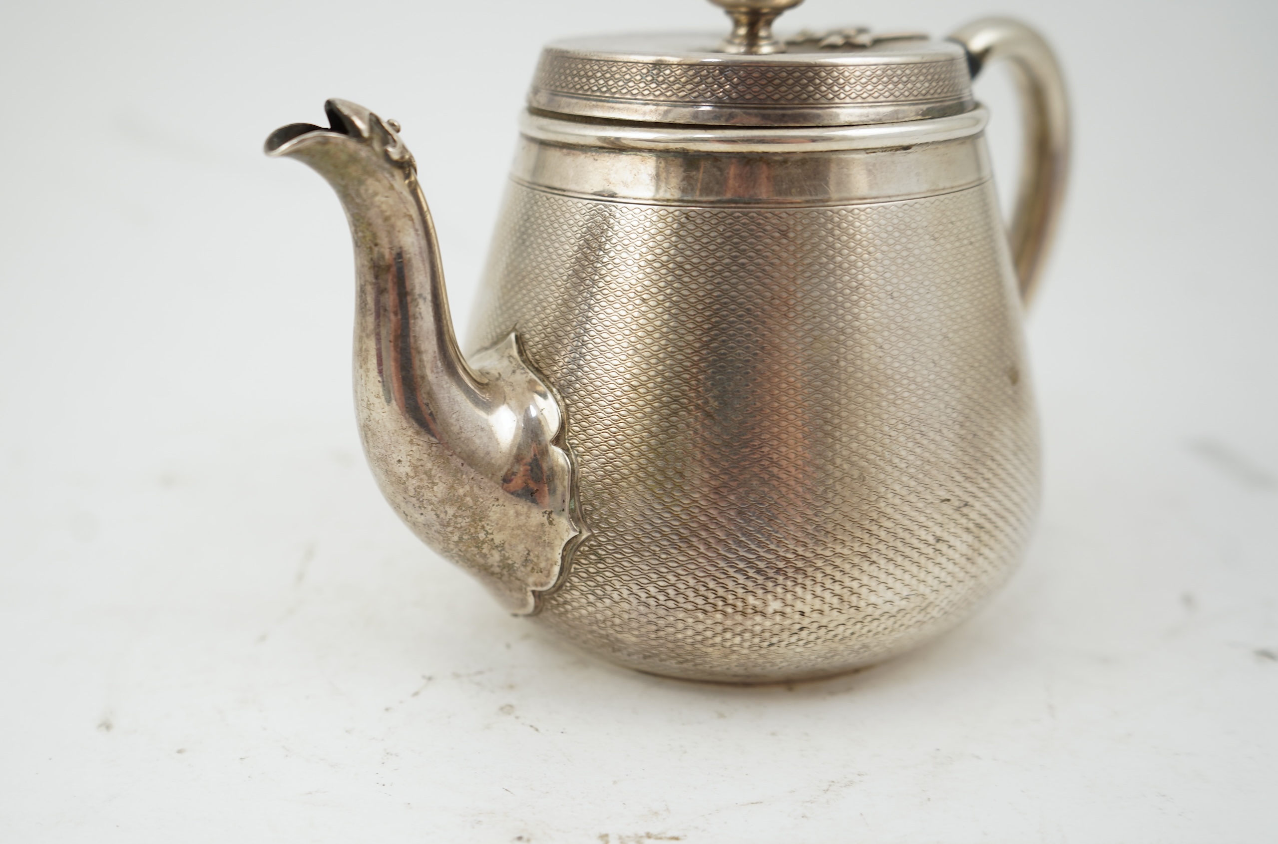A Victorian engine turned silver teapot by Hunt & Roskell